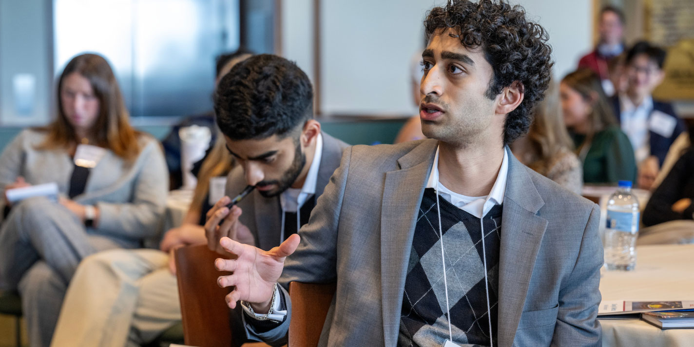 Student engaging in debate during a lecture