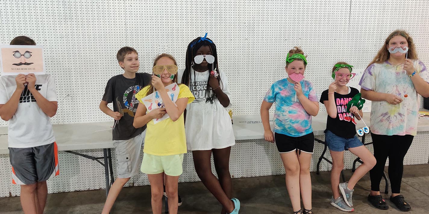 Kids posing for a silly picture with props