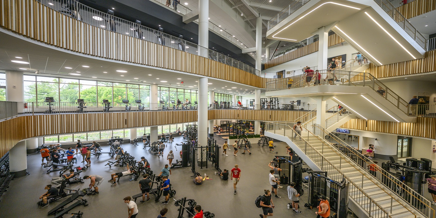 The fitness space on the first floor is bustling with people using strength equipment while the second and third floors have cardio equipment with a view of Lake Mendota at the Bakke Recreation & Wellbeing Center at the University of Wisconsin–Madison on Sept. 22, 2023. (Photo by Althea Dotzour / UW–Madison)