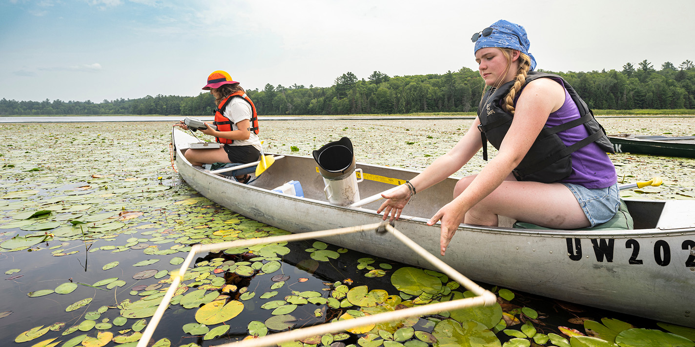 Students examining a lake