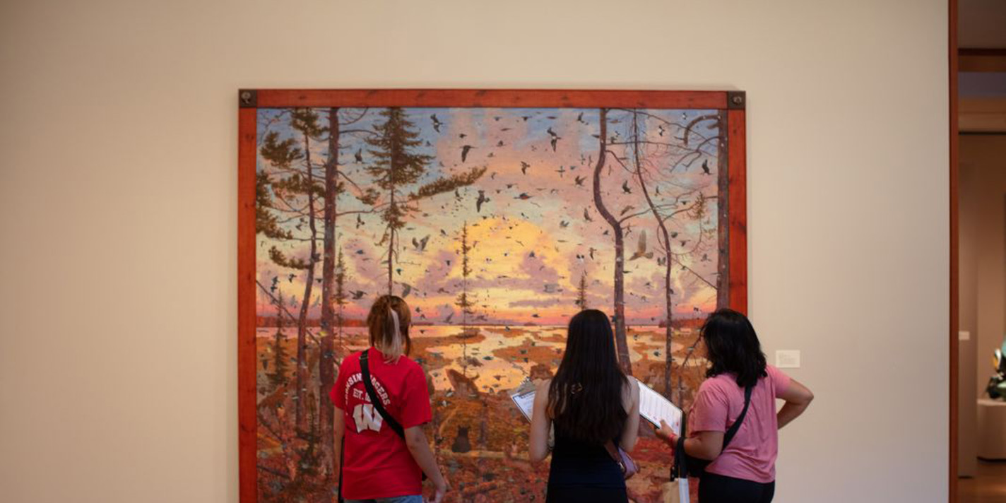 Students shown appreciating and analyzing a piece of art