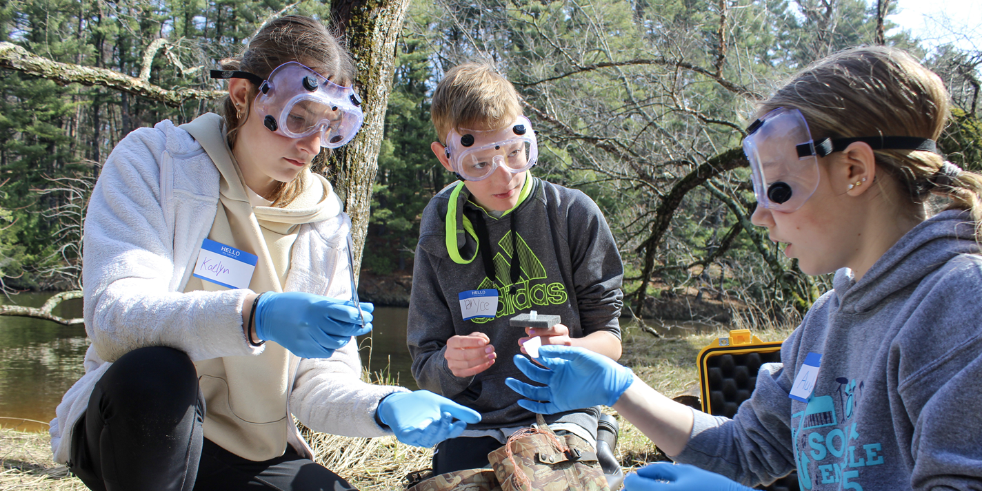 Children shown participating in an outdoor science experiment