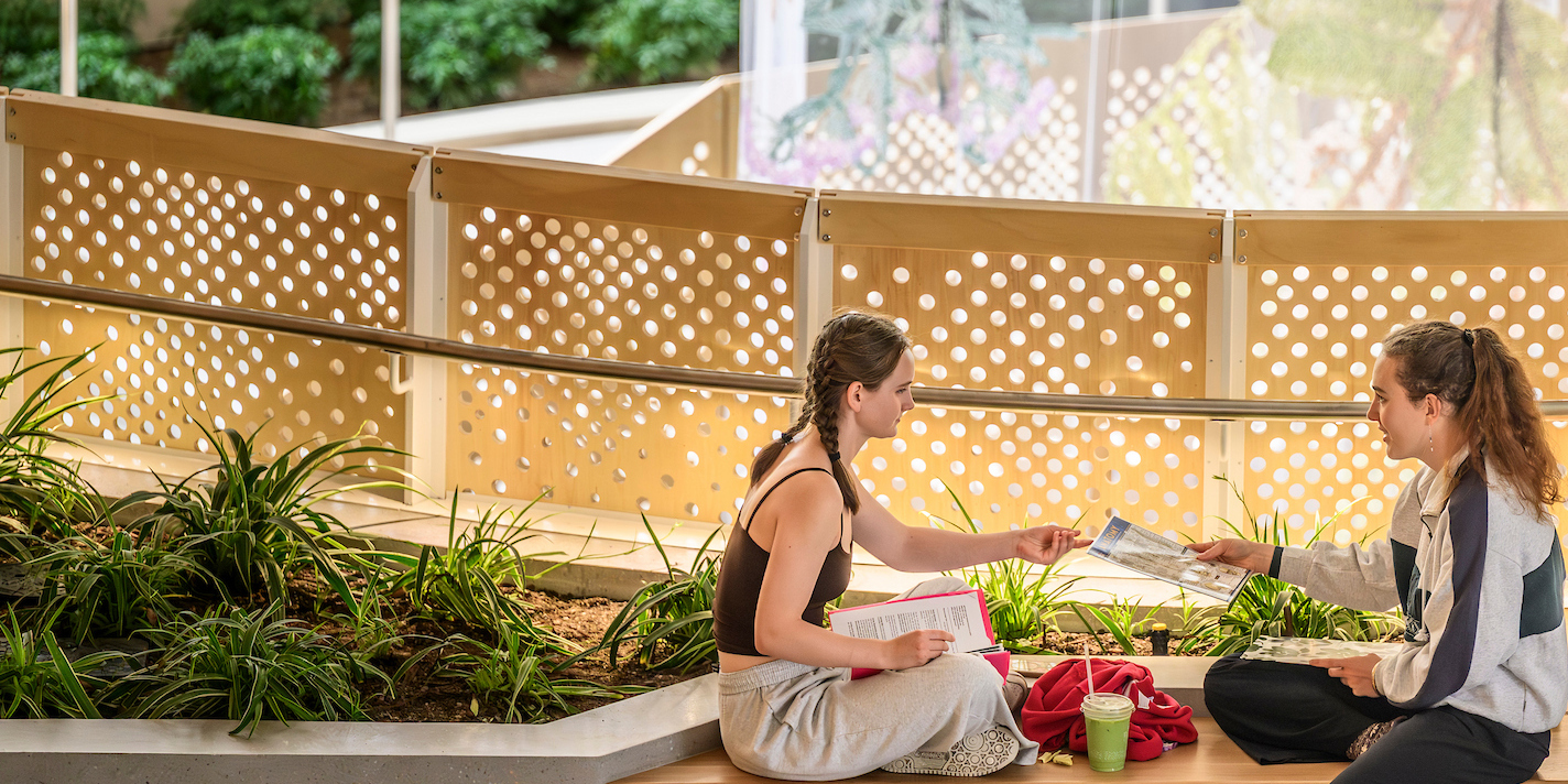 Students pause between classes at Morgridge Hall with the artwork “Suspended Landscapes” seen in the background on the first day of the fall semester at the University of Wisconsin–Madison