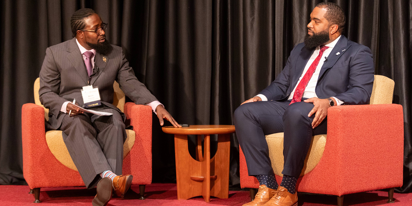 Two men having a discussion on a stage